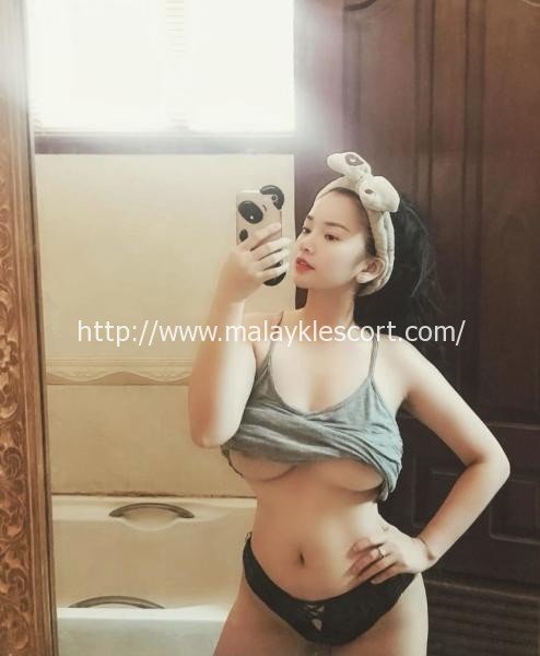 Kitty, a Vietnam Girl, takes a selfie in a mirror. Malay Escort, KL Escort, Malaysia Escort.