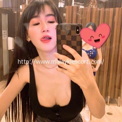 Jojo, a Thailand Girl, poses with a phone. Malay Escort, KL Girl Service.