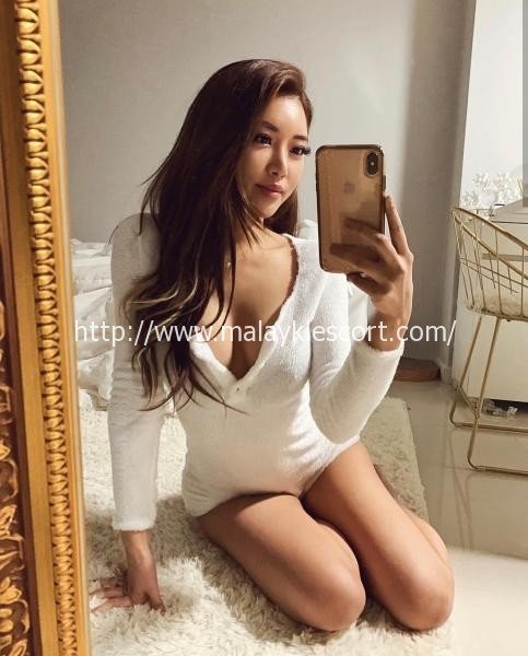Sensual Malay Escort in black lingerie, seductive pose. Kuala Lumpur Girl Service.