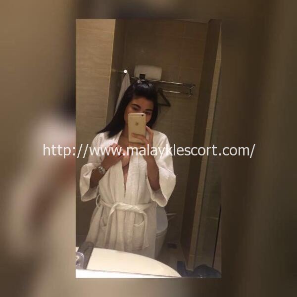 Malay Escort selfie in bathroom. KL Call Girl with tattoo and iPhone. Malaysia Escort.