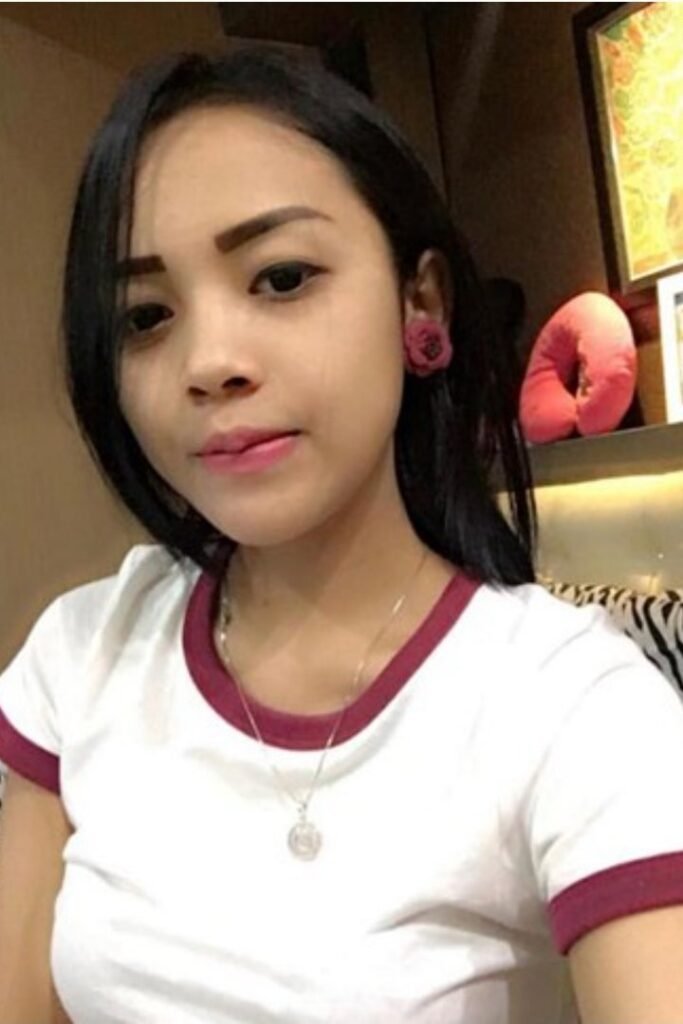 Hyana, a Malay Girl, wearing a white shirt with a necklace, possibly an Outcall Girl in Kuala Lumpur.