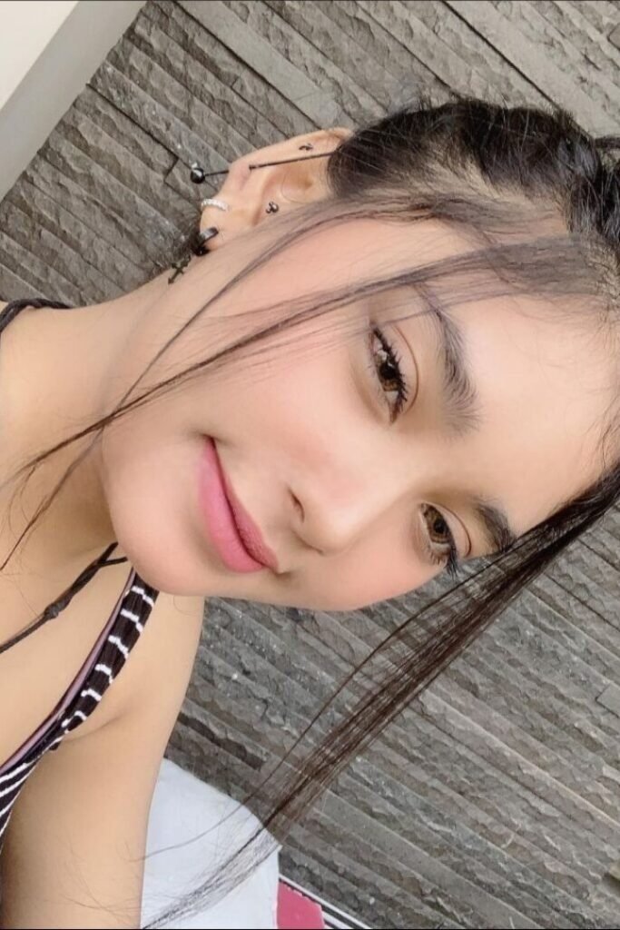 Syufida, a beautiful Malay girl with multiple ear piercings, posing for a selfie. Malay Escort, KL Escort.