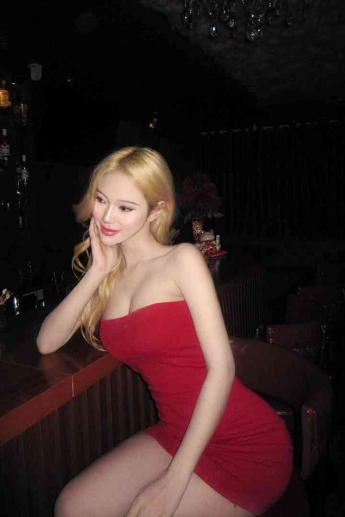 Elegant Erdene, a Mongolian Escort KL, in a red dress. Malaysia Escort services.