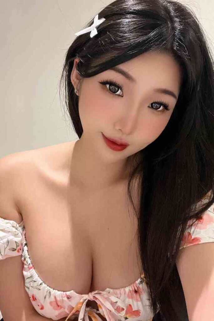 Attractive Asian woman with floral top. KL Escort, Sex Escort, Outcall Girl.