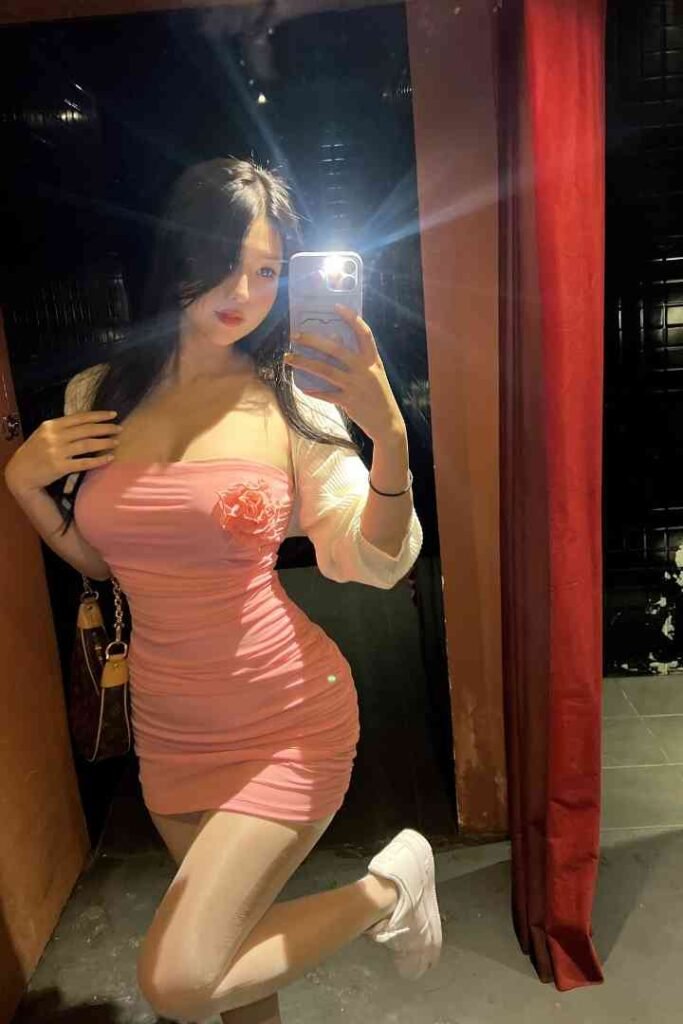 Nomin, alluring KL Escort in pink dress and white cardigan. Incall & Outcall Sex Services in Kuala Lumpur.